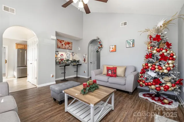 a living room with furniture and flowers