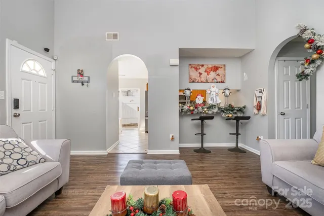 a living room with furniture and painting on the wall