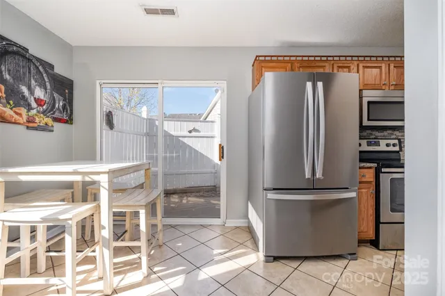 a kitchen with stainless steel appliances granite countertop a refrigerator and a stove