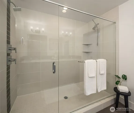 a bathroom with a shower and a mirror