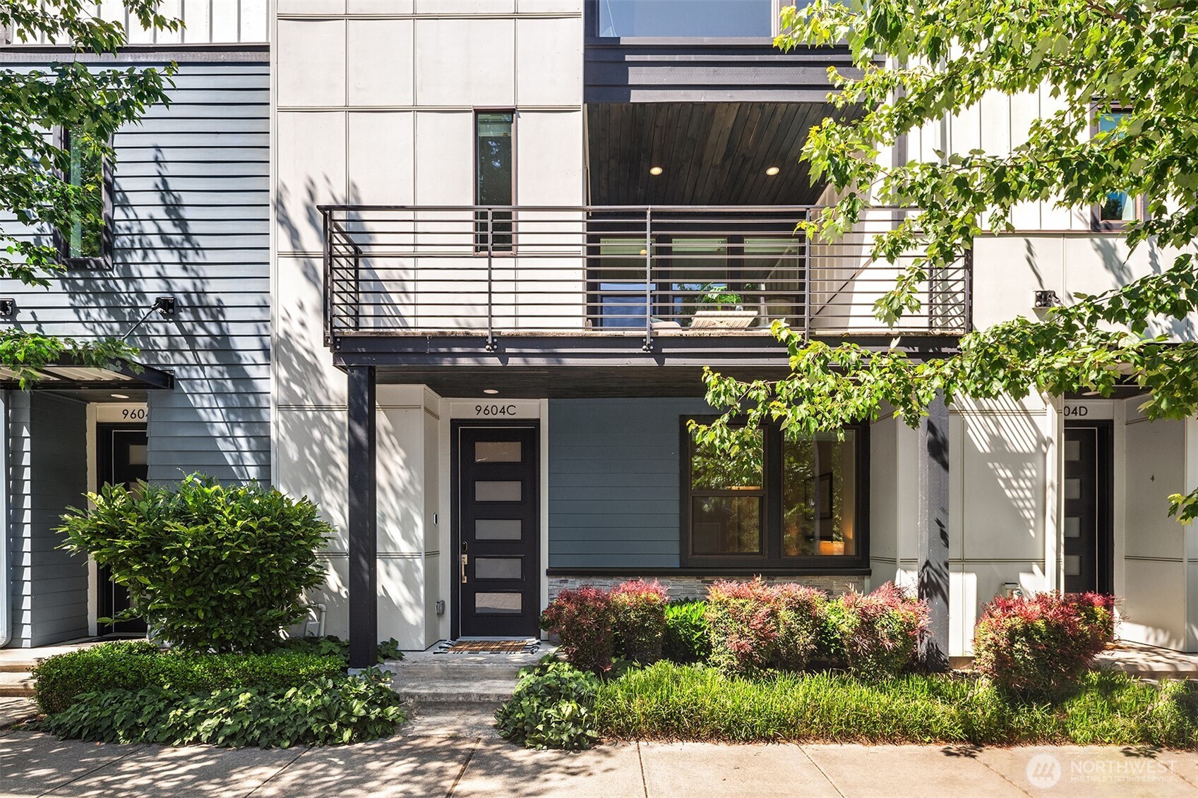 9604 Main Street, Unit C Bothell, WA 98011 - Photo 2 of 32 a front view of a house with a yard
