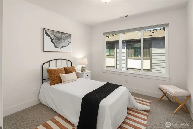 a bedroom with bed and a window