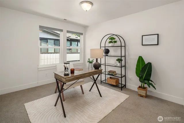 a living room with furniture a window and a potted plant