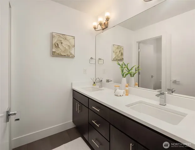 a bathroom with a double vanity sink and a mirror