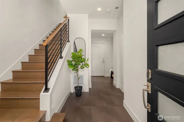 a view of an entryway with wooden floor