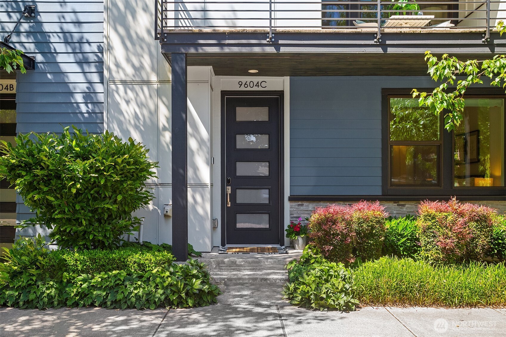9604 Main Street, Unit C Bothell, WA 98011 - Photo 31 of 32 front view of a brick house with potted plants
