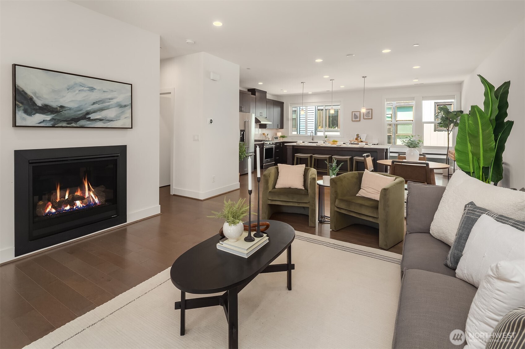 9604 Main Street, Unit C Bothell, WA 98011 - Photo 5 of 32 a living room with furniture a kitchen and a fireplace