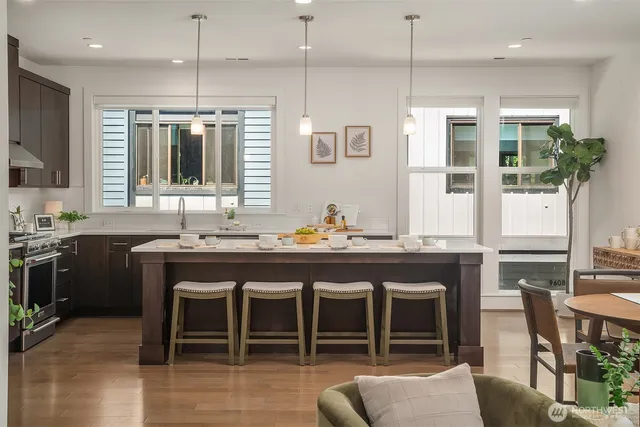 a kitchen with kitchen island granite countertop a table and chairs in it