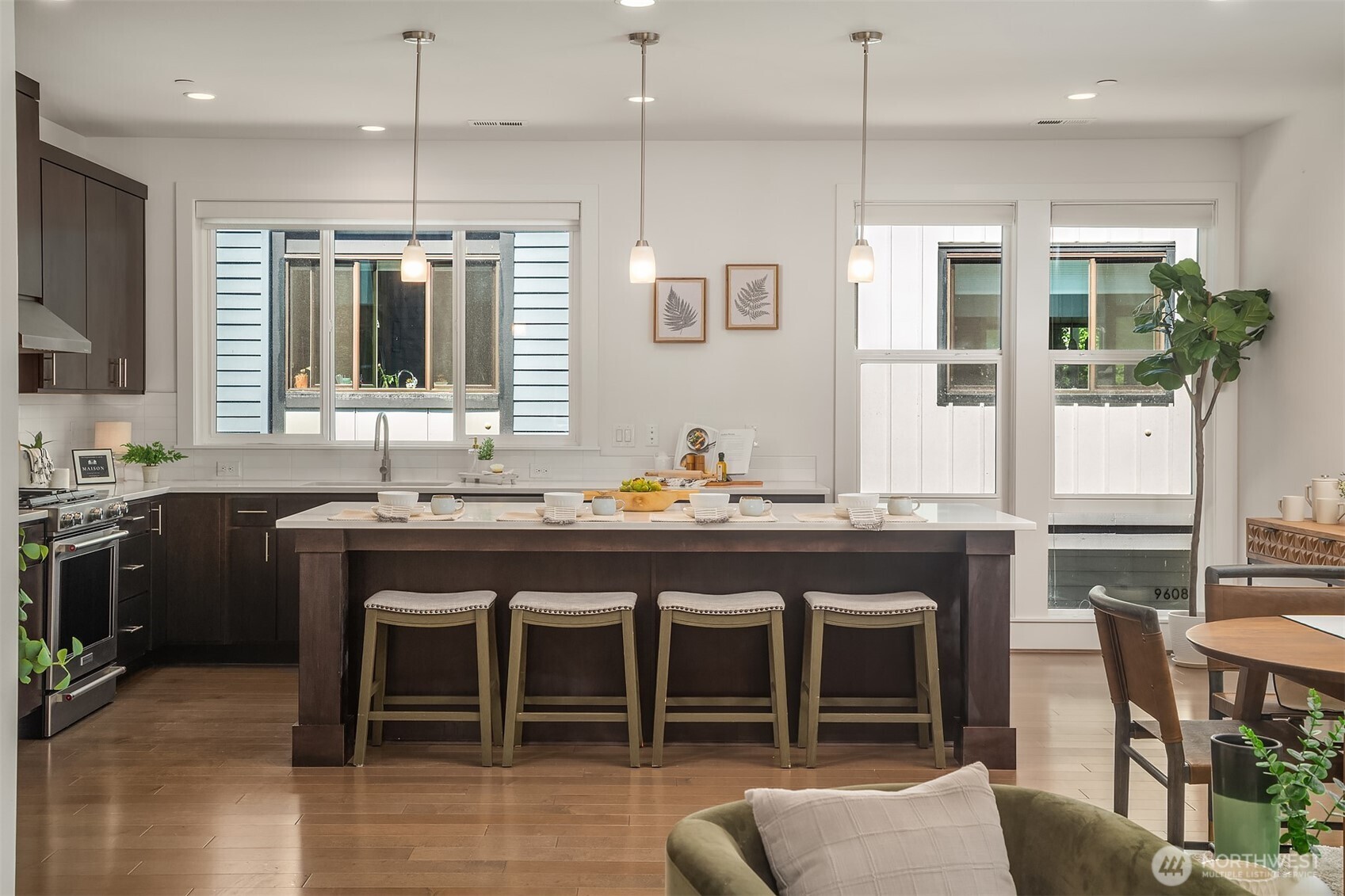 9604 Main Street, Unit C Bothell, WA 98011 - Photo 7 of 32 a kitchen with kitchen island granite countertop a table and chairs in it
