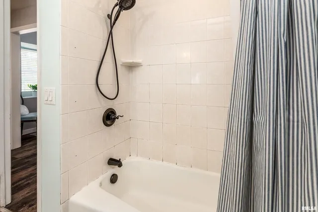 a bathroom with a bathtub and shower