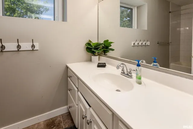 a bathroom with a sink a toilet and a mirror