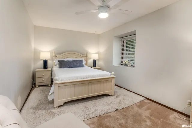 a bedroom with a bed and painting on the wall