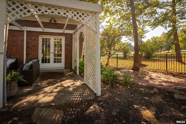 an aerial view of residential houses with outdoor space and trees all around