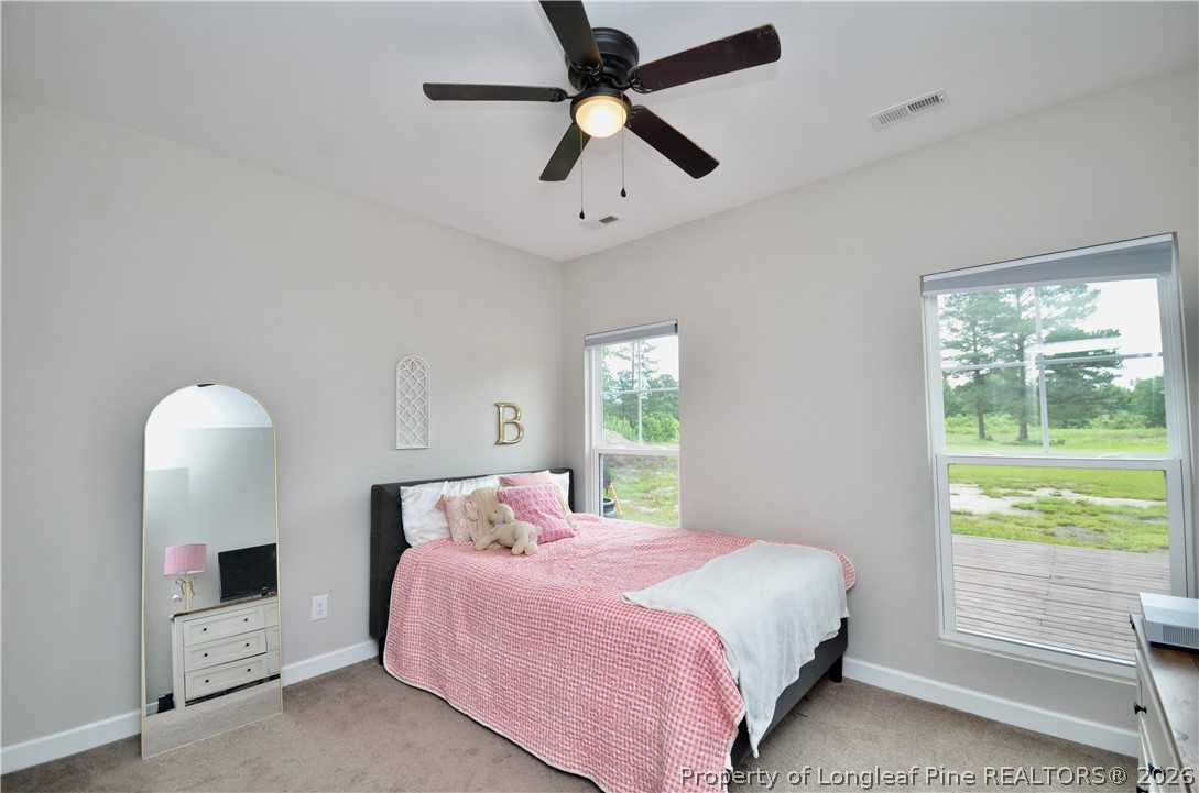 1865 John B Carter Road Fayetteville, NC 28312 - Photo 23 of 49 a bedroom with a bed and a large window