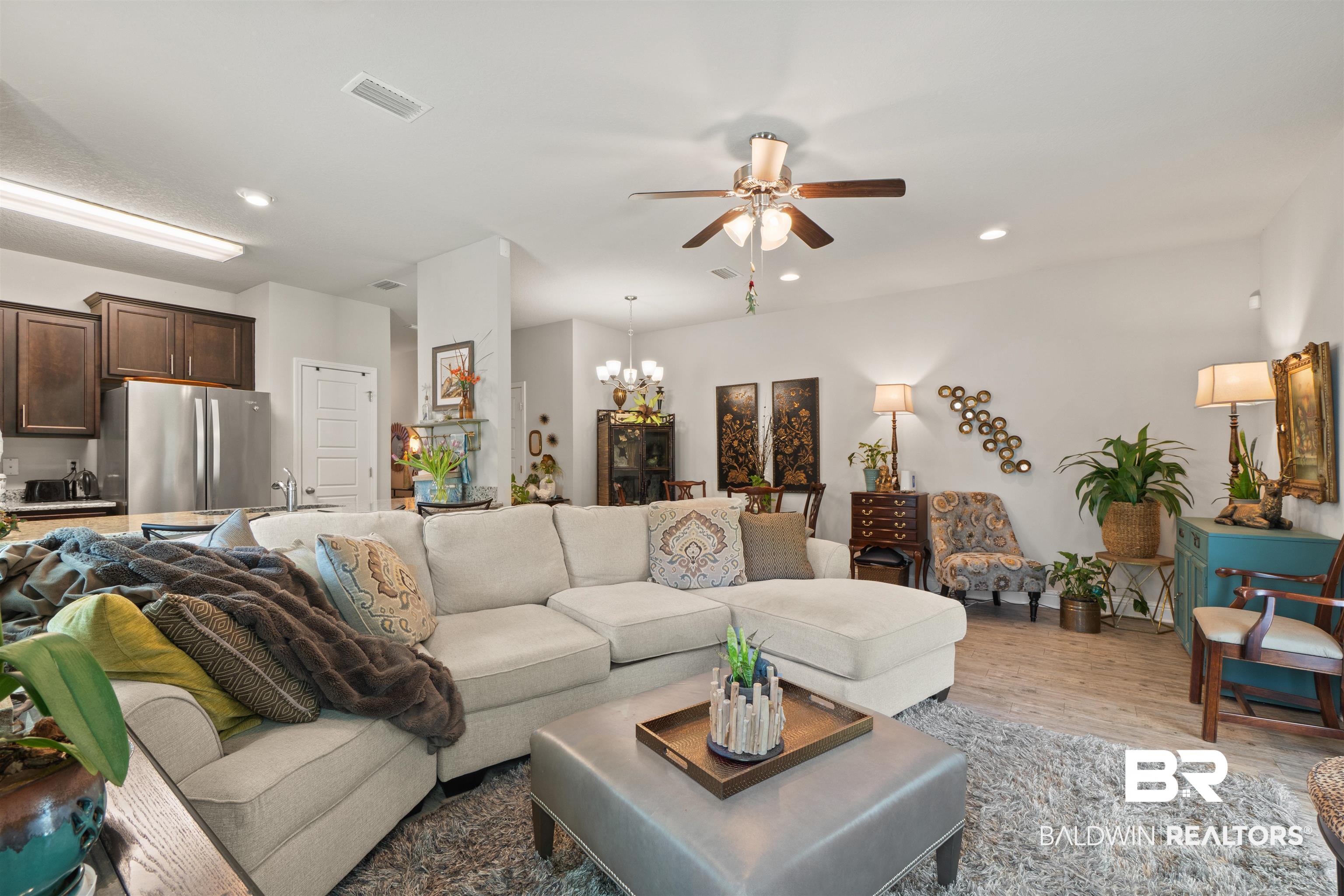 25806 Pollard Road, Unit 6 Daphne, AL 36526 - Photo 6 of 38 Spacious open-concept living area featuring light-toned walls and wood-finish flooring
