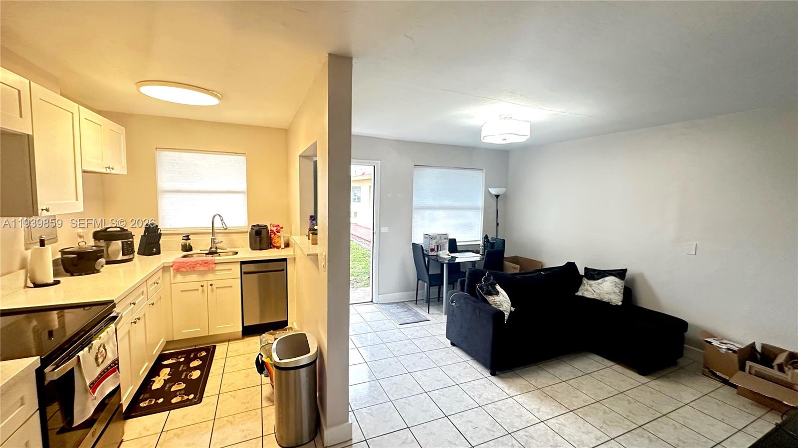 2651 Northwest 13th Street, Unit 41 Miami, FL 33125 - Photo 4 of 12 a living room with furniture and a large window