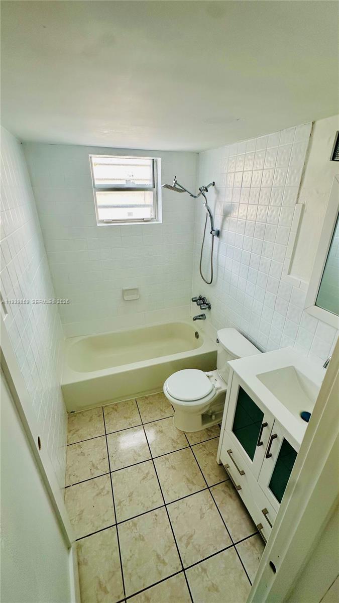 2651 Northwest 13th Street, Unit 41 Miami, FL 33125 - Photo 4 of 6 a bathroom with a sink and a mirror
