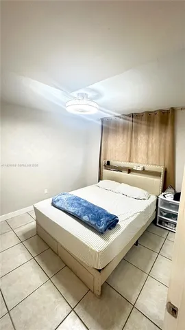 a spacious bedroom with a bed and a cabinets