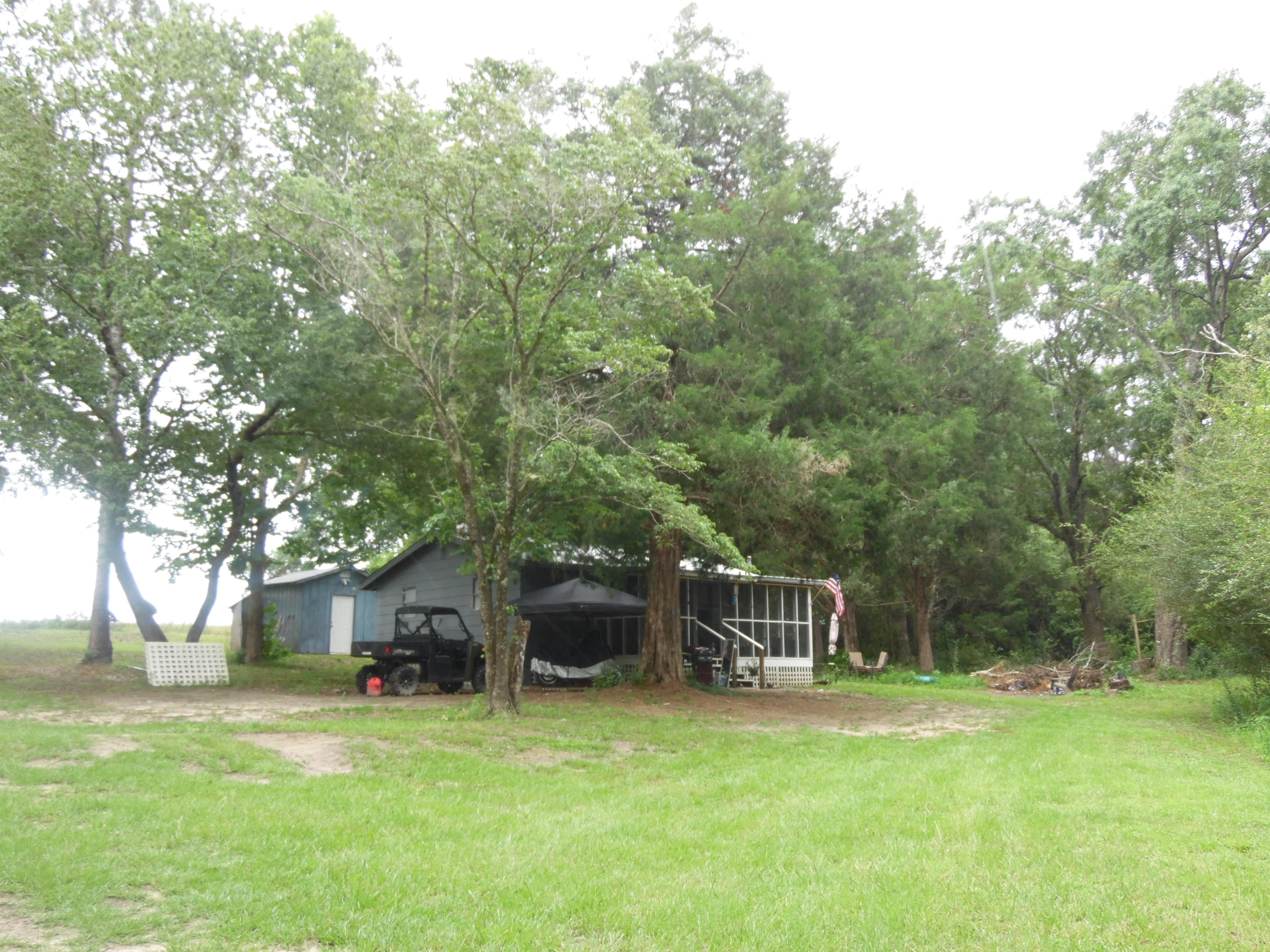 792 Mims Road DeFuniak Springs, FL 32433 - Photo 4 of 16 a white house that has a tree in front of it