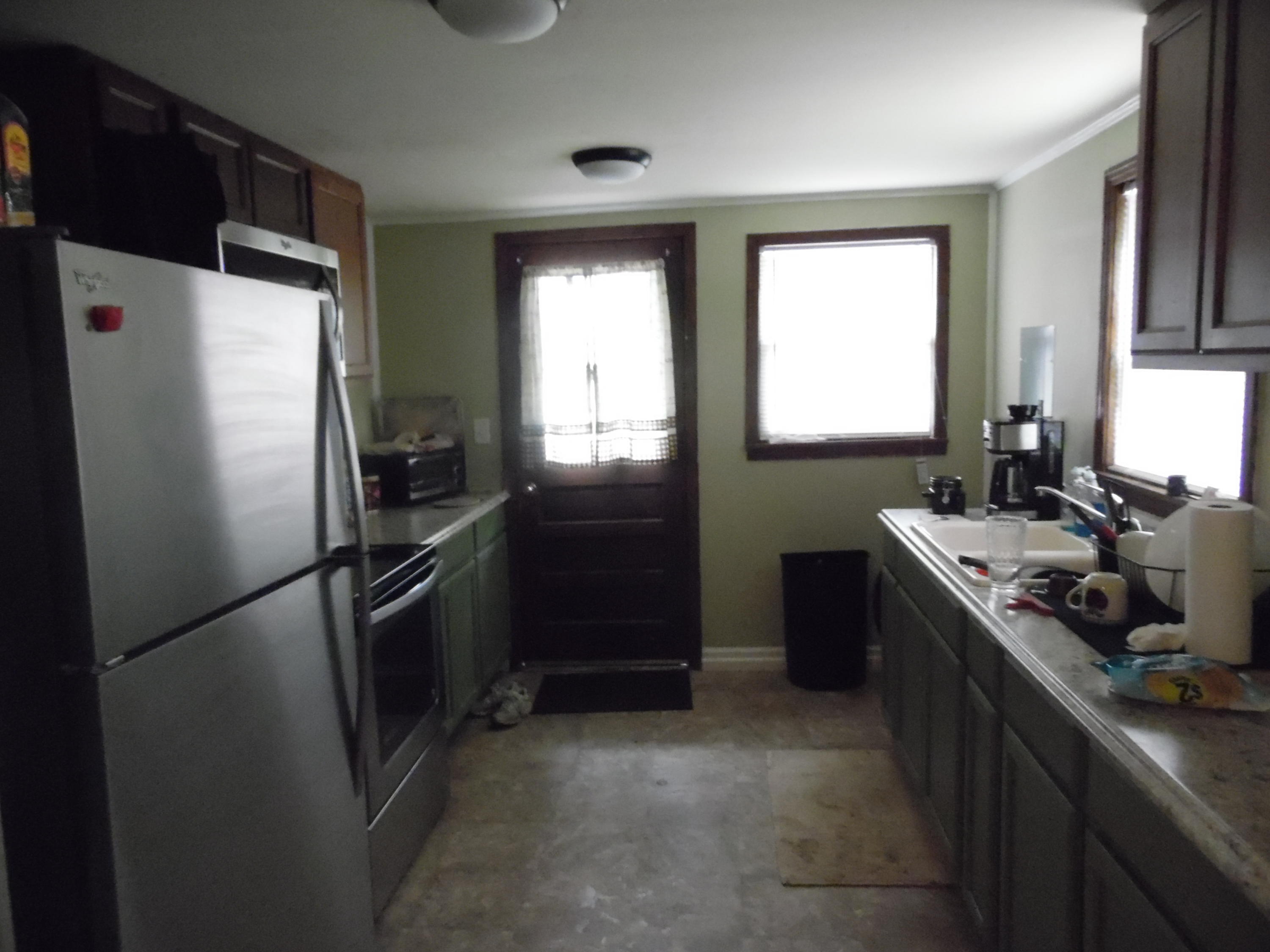 792 Mims Road DeFuniak Springs, FL 32433 - Photo 8 of 16 a kitchen with a refrigerator stove and sink