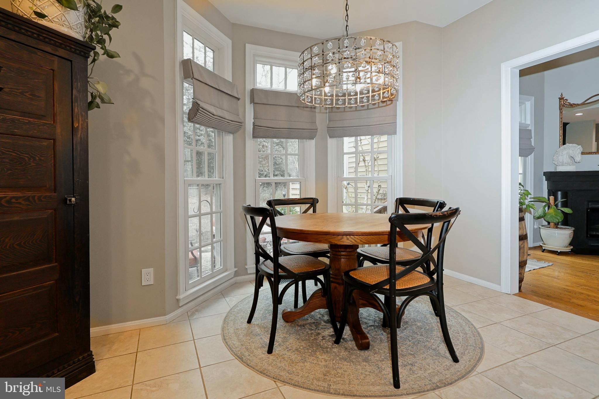 11423 Hollow Timber Way Reston, VA 20194 - Photo 18 of 68 a view of a dining room with furniture and chandelier