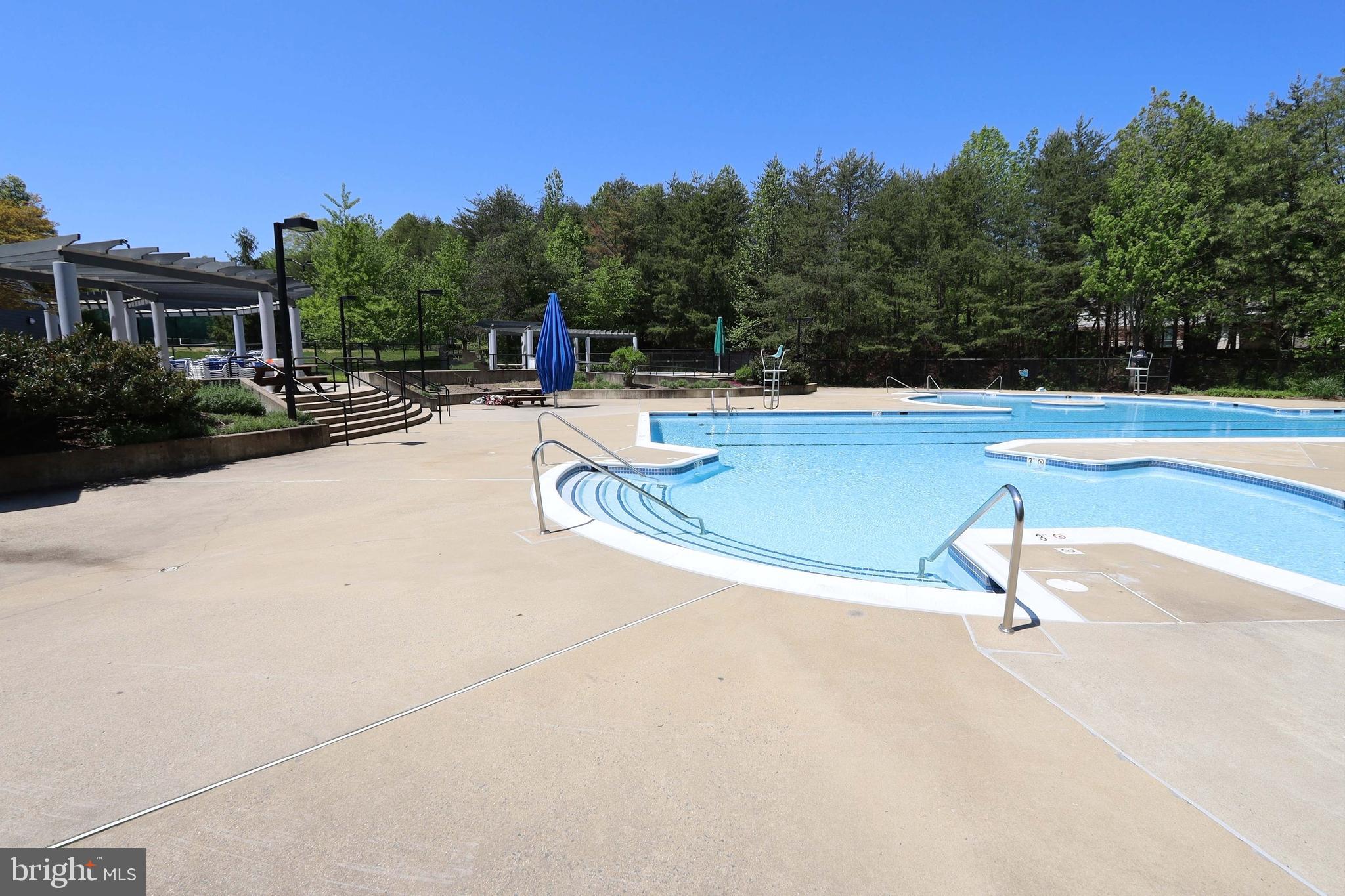 11423 Hollow Timber Way Reston, VA 20194 - Photo 57 of 68 a swimming pool with outdoor seating and garden