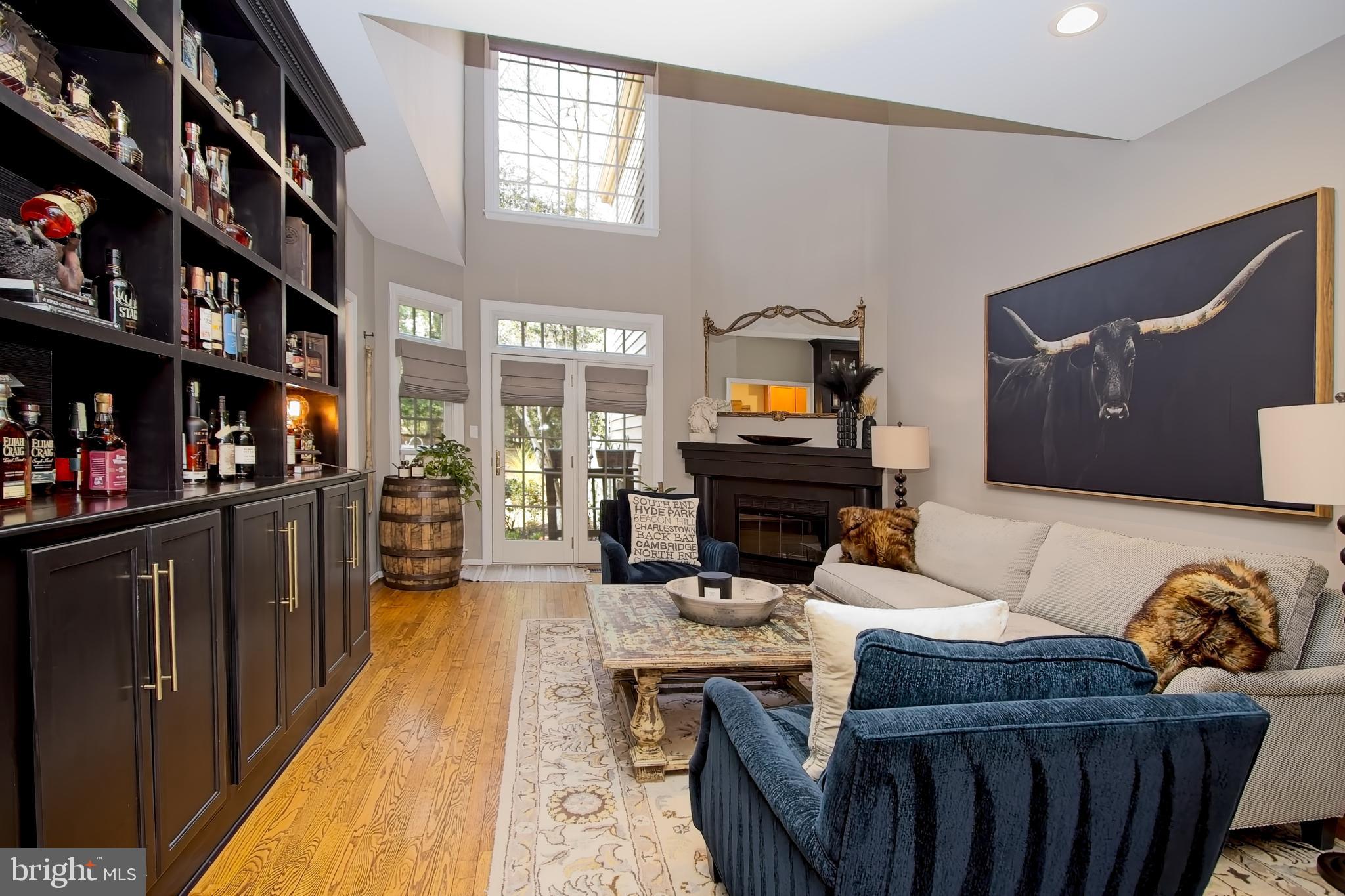 11423 Hollow Timber Way Reston, VA 20194 - Photo 7 of 68 a living room with furniture a flat screen tv and a book shelf