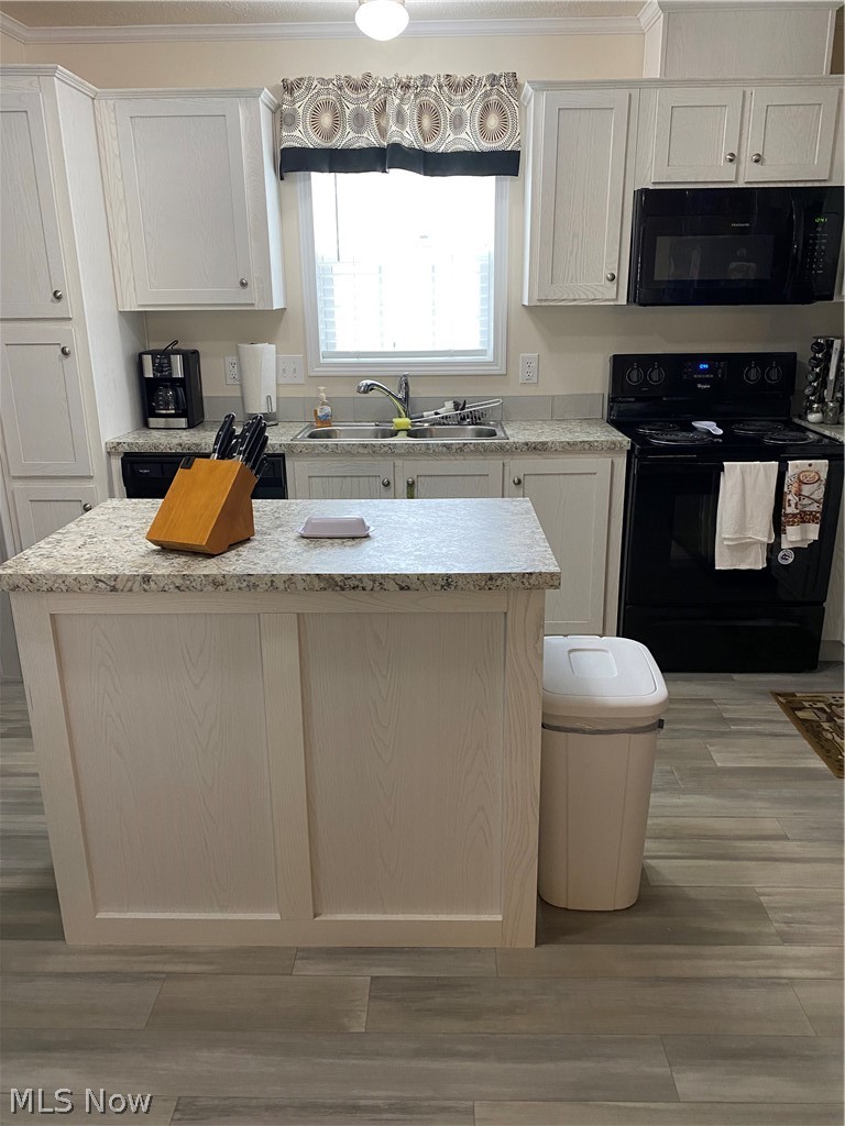 2700 Brookpark Road, Unit 626 Cleveland, OH 44134 - Photo 3 of 32 Kitchen with light stone counters, stove, a center island, white cabinets, and sink