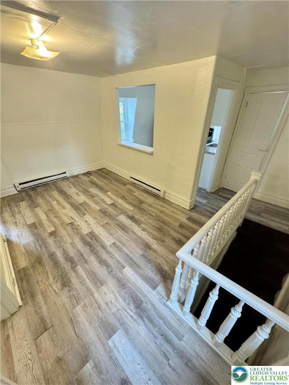 812 Chestnut Street, Unit B Allentown, PA 18101 - Photo 3 of 9 a view of an empty room with wooden floor and a window
