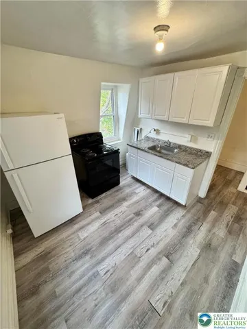 a large empty room with wooden floor