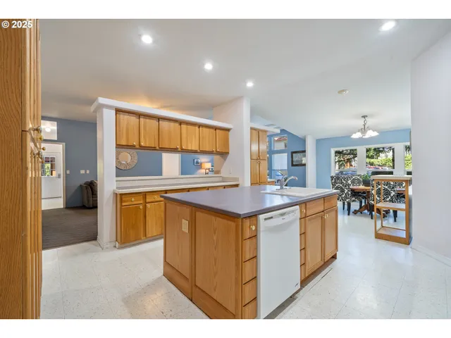 a kitchen with stainless steel appliances granite countertop a stove and a refrigerator