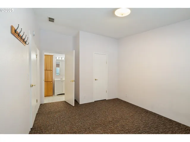 a bathroom with a granite countertop sink mirror and a shower