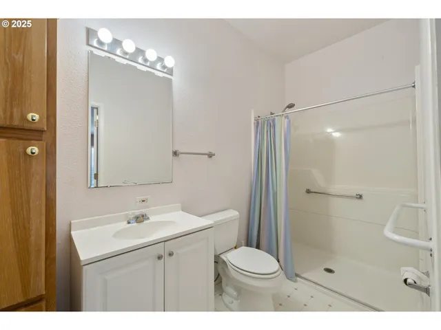 a bathroom with a sink vanity and a mirror