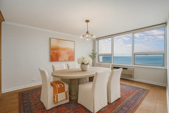 a view of a dining room with furniture window and wooden floor