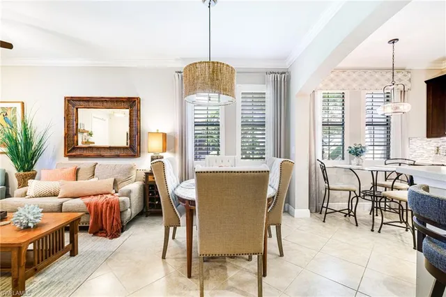 a kitchen with a table chairs and refrigerator