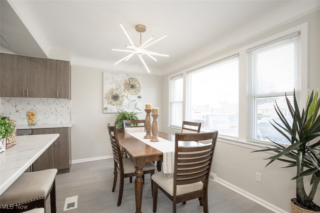 4631 Belfiore Road Cleveland, OH 44128 - Photo 6 of 28 Dining space with tile flooring and a chandelier