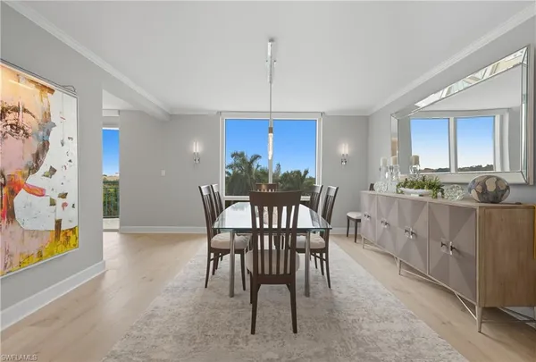 a view of a dining room with furniture and chandelier