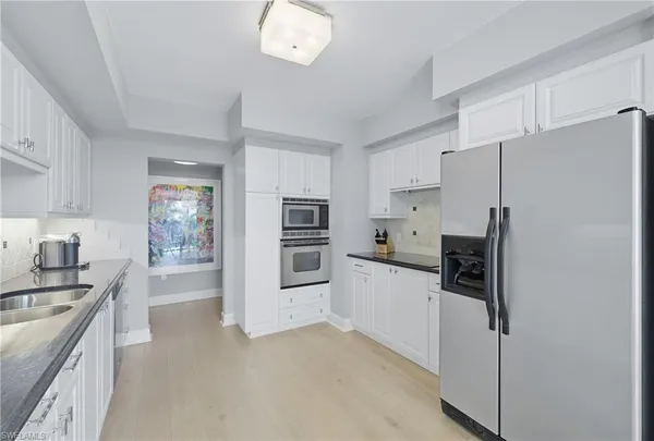 a kitchen with stainless steel appliances a refrigerator stove and sink