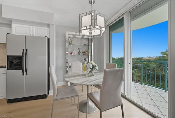 a dining room with furniture a chandelier and window