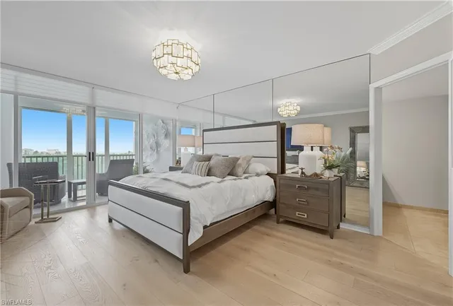 a spacious bedroom with a bed and a chandelier