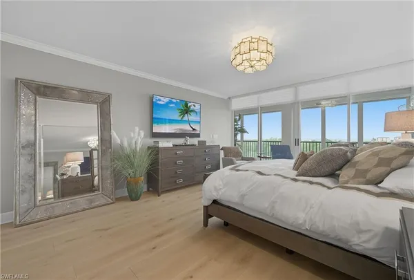 a bedroom with a bed and a chandelier