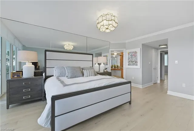 a bedroom with a bed and a chandelier