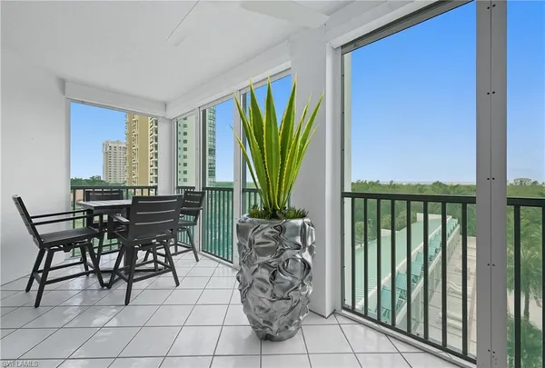 a view of a dining room with furniture and a window