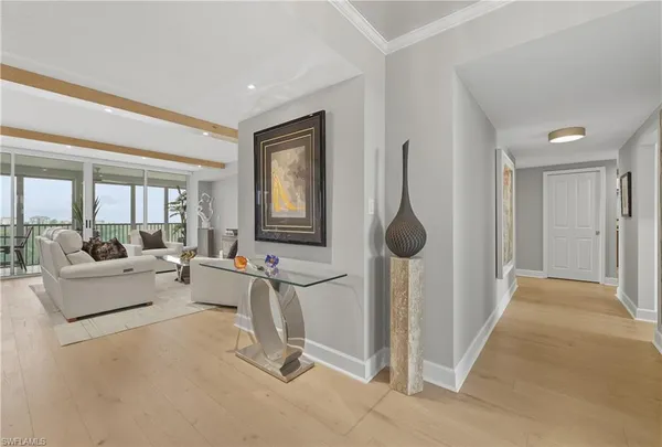 a living room with furniture a large window and a chandelier