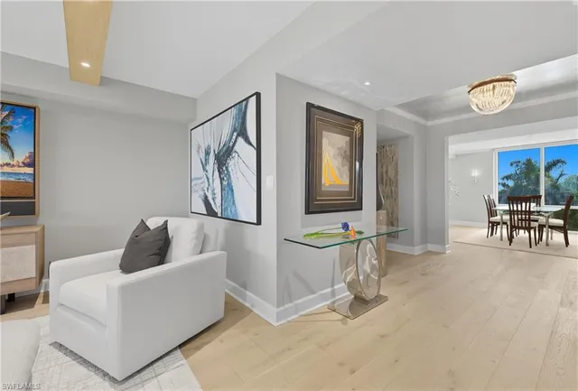 a living room with furniture and floor to ceiling window
