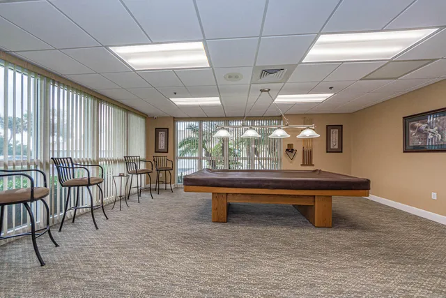 a view of game room with windows