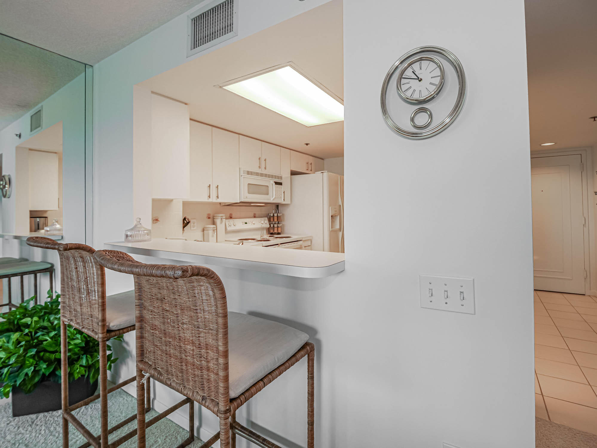 2700 North Hwy A1A, Unit 307 Hutchinson Island, FL 34949 - Photo 29 of 51 a kitchen with granite countertop a table and chairs