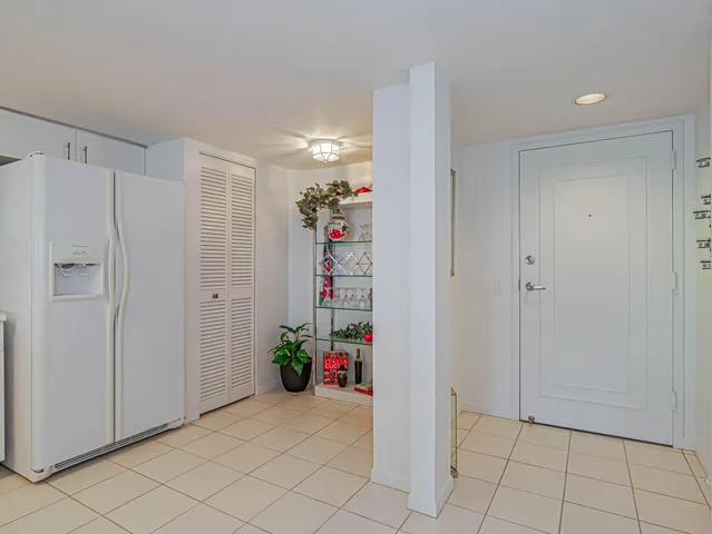 a kitchen with white cabinets a sink and white appliances