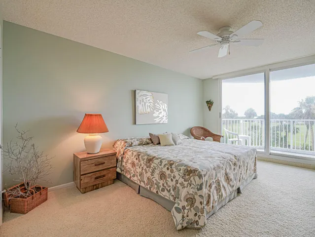 a bedroom with a large bed and a large window