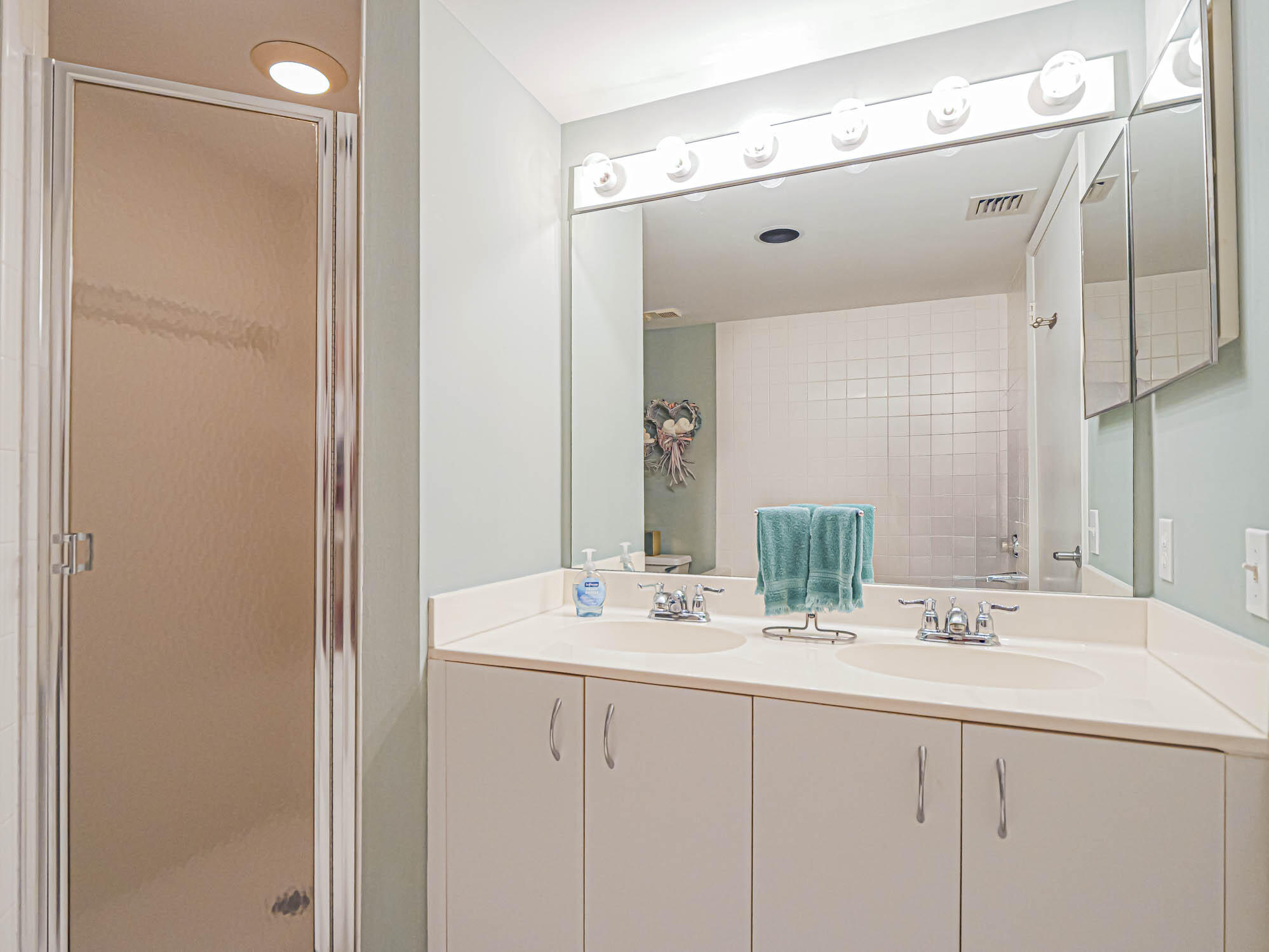 2700 North Hwy A1A, Unit 307 Hutchinson Island, FL 34949 - Photo 40 of 51 a bathroom with a double vanity sink and a mirror
